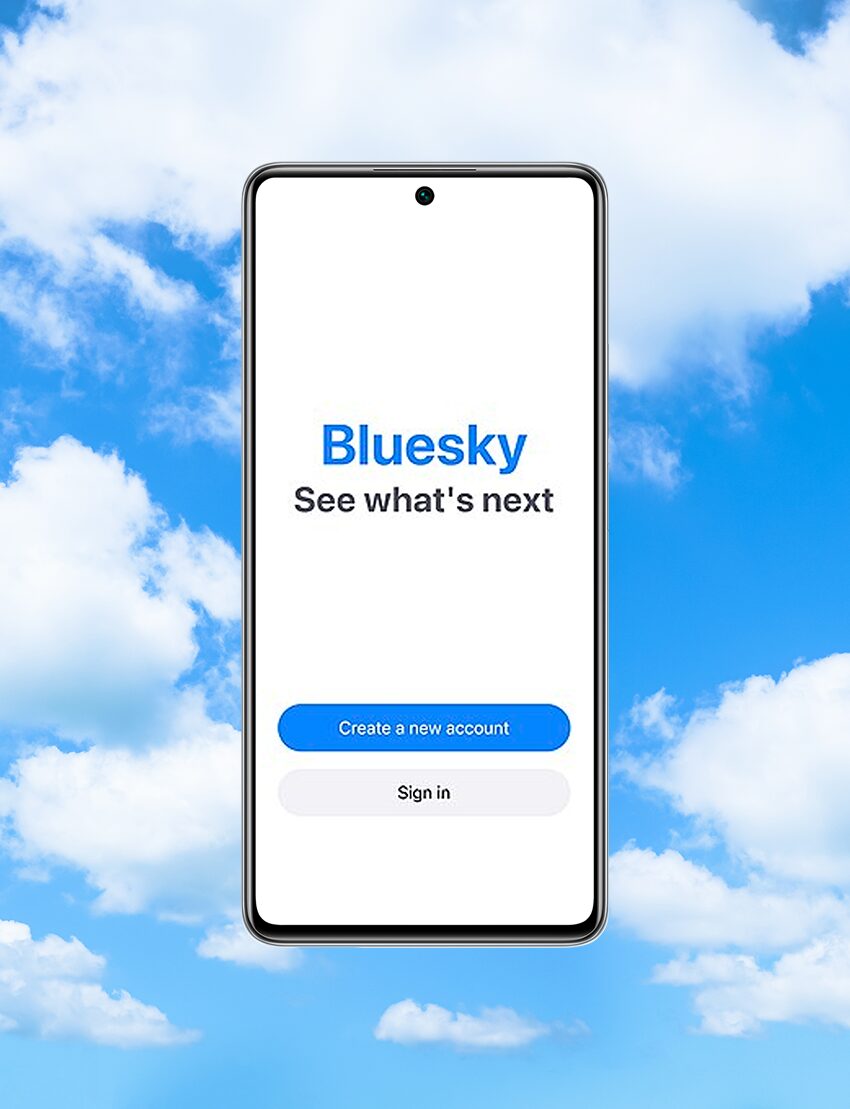 Bluesky App on mobile phone against a sky background
