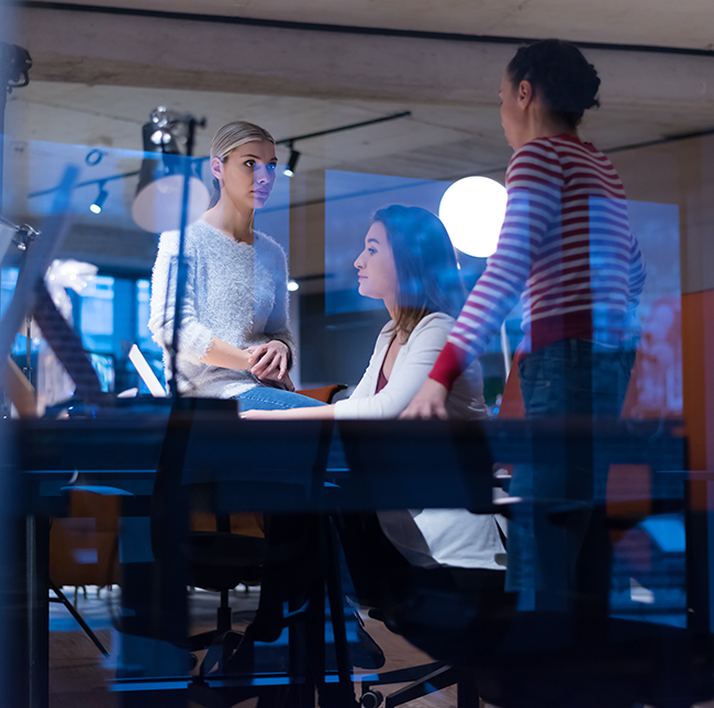 Business team working in a glass-walled meeting room