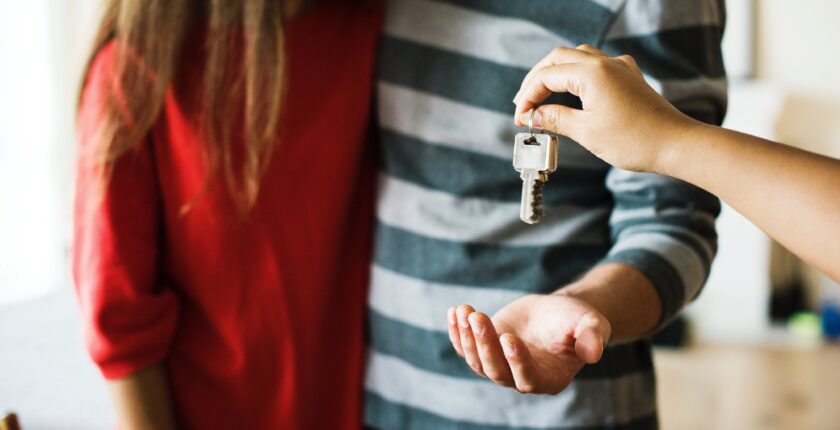 couple getting keys from realtor to new home