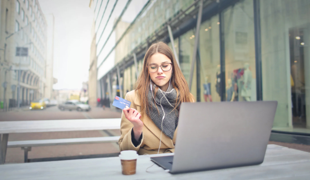 woman unsure about whether to complete a purchase online