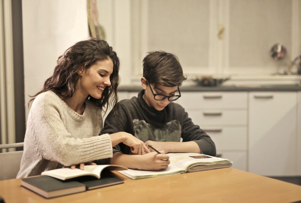 Woman helping child with homework