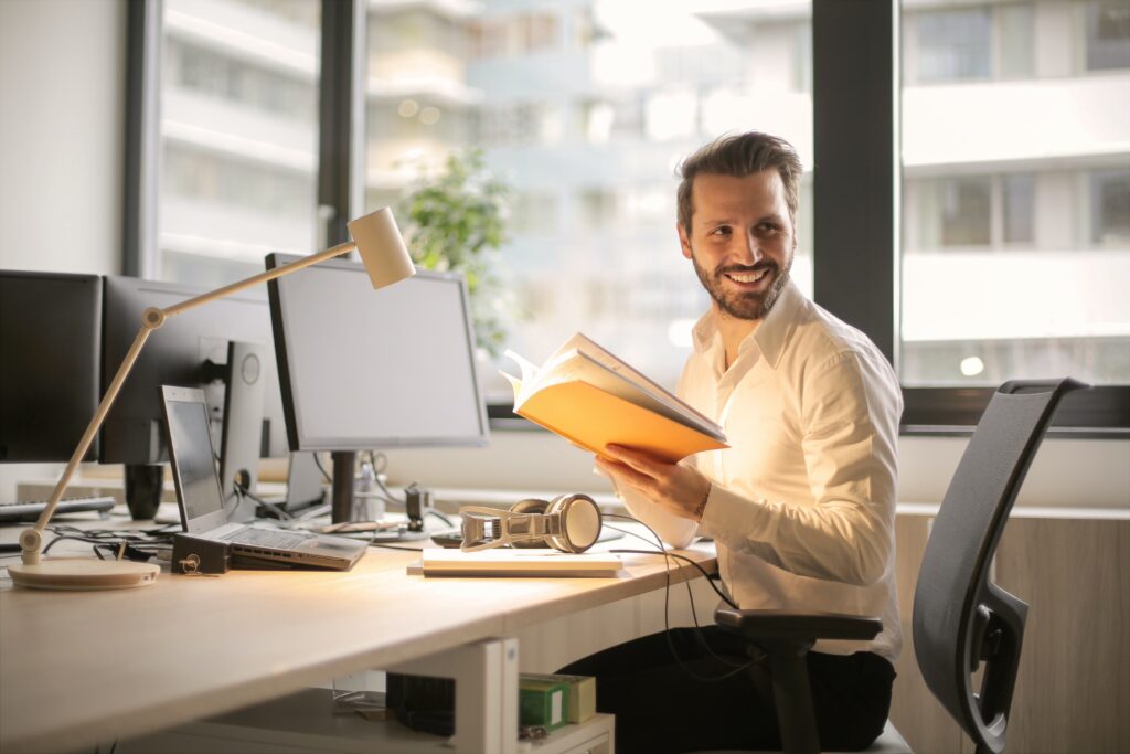 Domain broker in an office holding a book