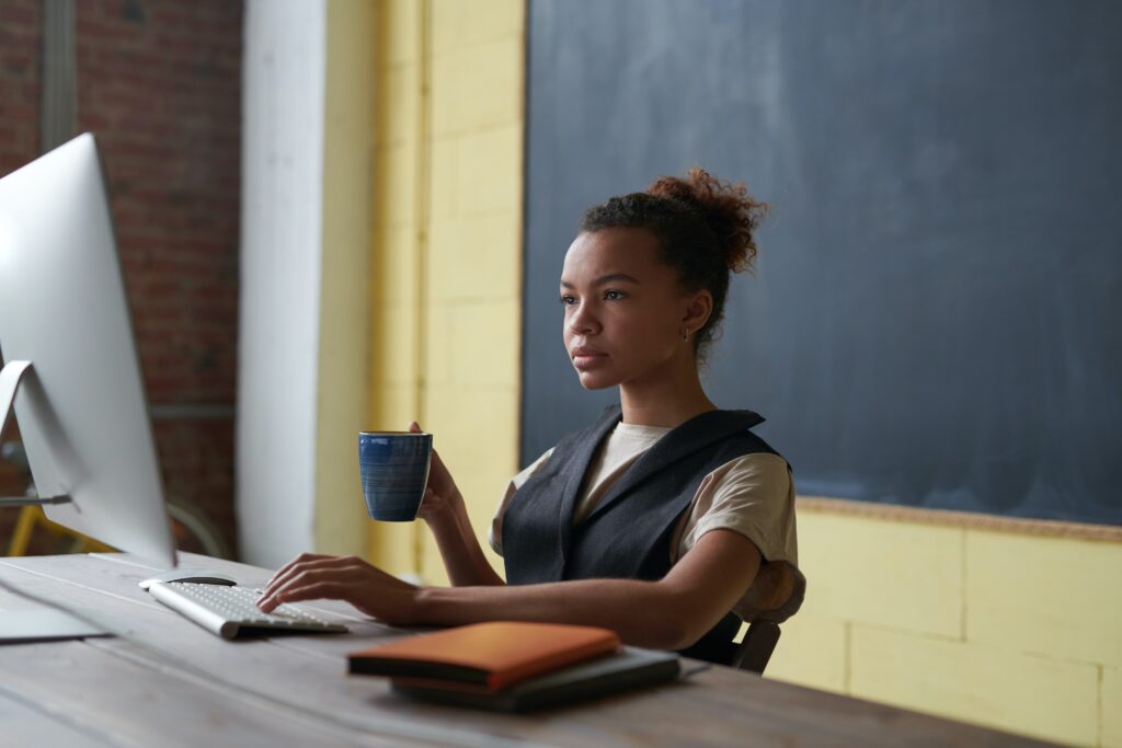 Woman using her desktop to learn more about domain investing.