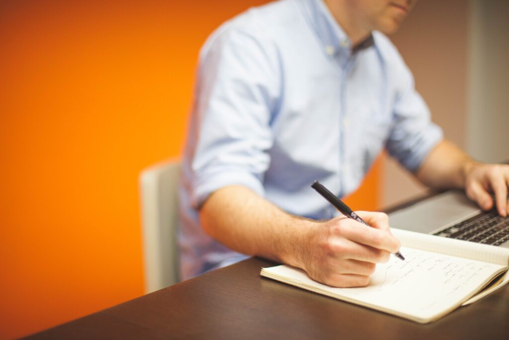 Closeup of a domain broker taking notes